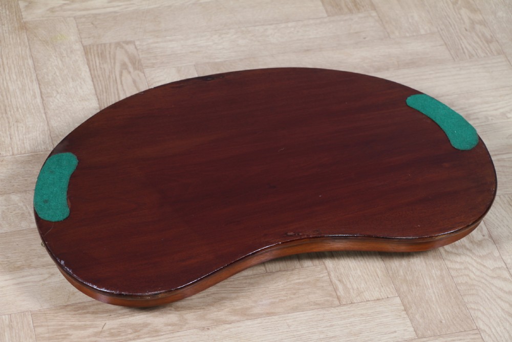 An Edwardian kidney-shaped solid mahogany serving tray featuring a central inlaid shell motif and two brass carrying handles. View XX