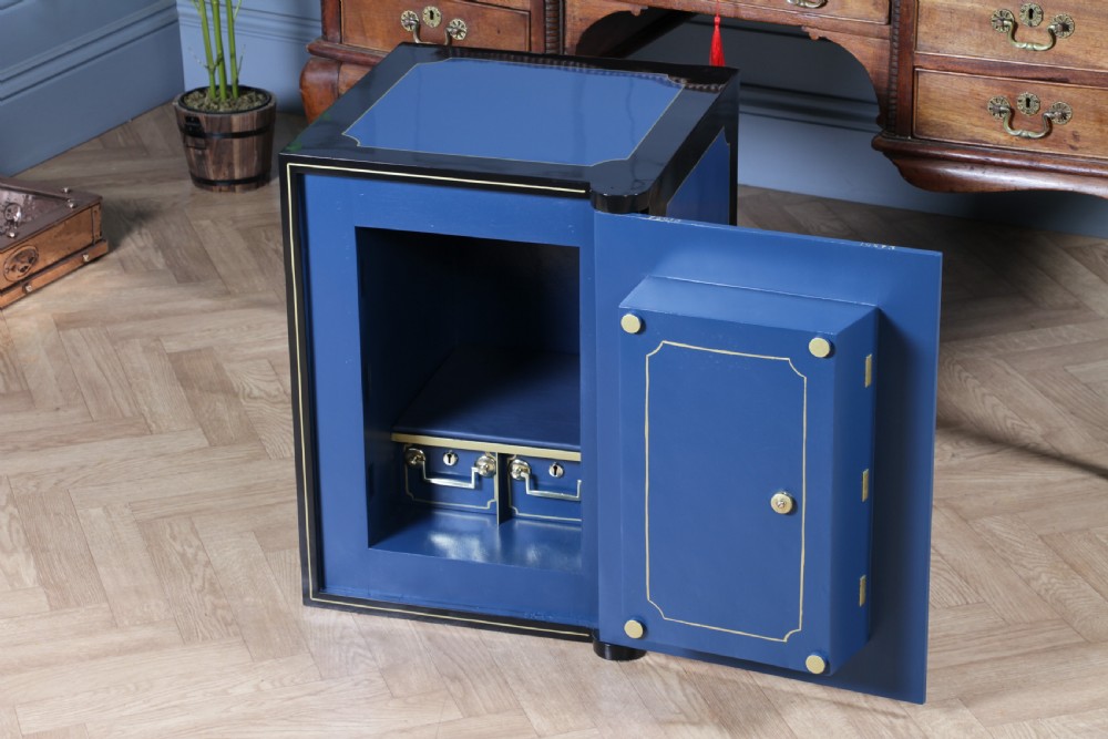 A heavy restored Victorian cast iron safe featuring a deep blue and black lacquered exterior with gold pinstriping and a brass royal coat of arms crest. View VII