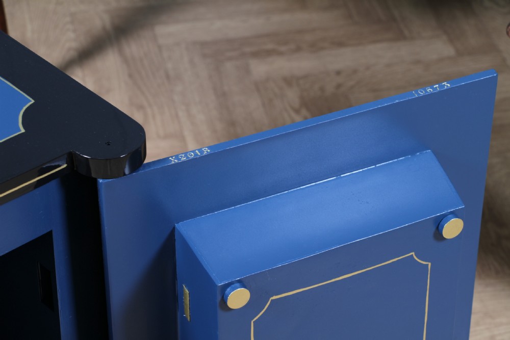 A heavy restored Victorian cast iron safe featuring a deep blue and black lacquered exterior with gold pinstriping and a brass royal coat of arms crest. View XV