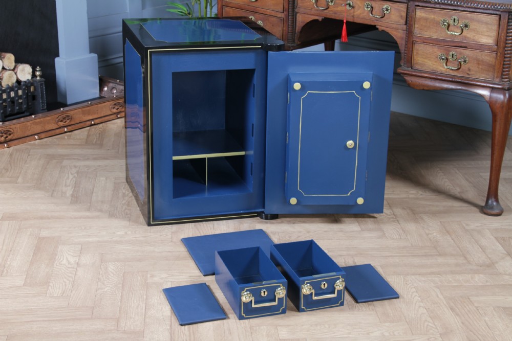 A heavy restored Victorian cast iron safe featuring a deep blue and black lacquered exterior with gold pinstriping and a brass royal coat of arms crest. View XX