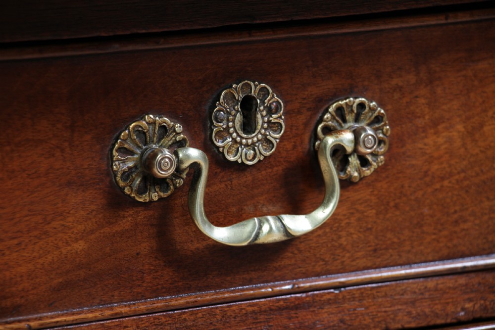 A Georgian mahogany writing desk featuring a rectangular top, central kneehole drawer flanked by side drawers, polished brass handles, and cabriole legs ending in pad feet. View VI
