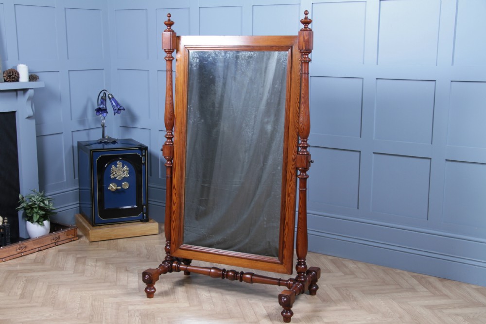 Victorian pitch pine cheval mirror featuring turned upright pillars, decorative finials, and a large tilting glass plate. View III