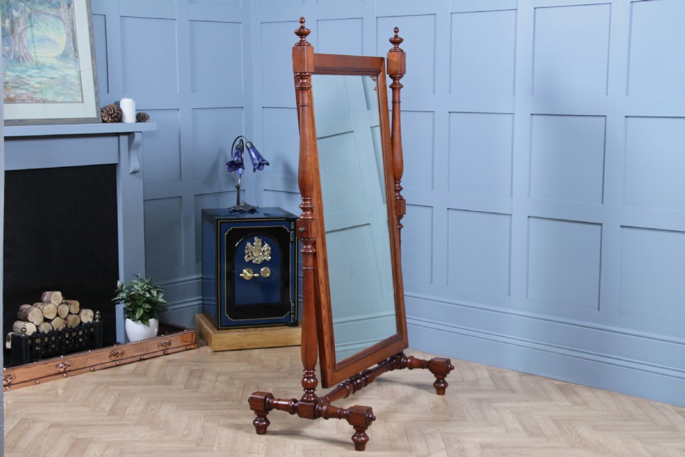 Victorian pitch pine cheval mirror featuring turned upright pillars, decorative finials, and a large tilting glass plate. View XII