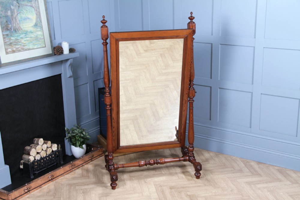 Victorian pitch pine cheval mirror featuring turned upright pillars, decorative finials, and a large tilting glass plate. View XIV