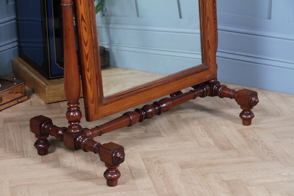 Victorian pitch pine cheval mirror featuring turned upright pillars, decorative finials, and a large tilting glass plate. View XVI
