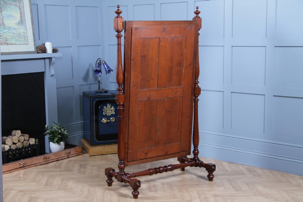 Victorian pitch pine cheval mirror featuring turned upright pillars, decorative finials, and a large tilting glass plate. View XVII