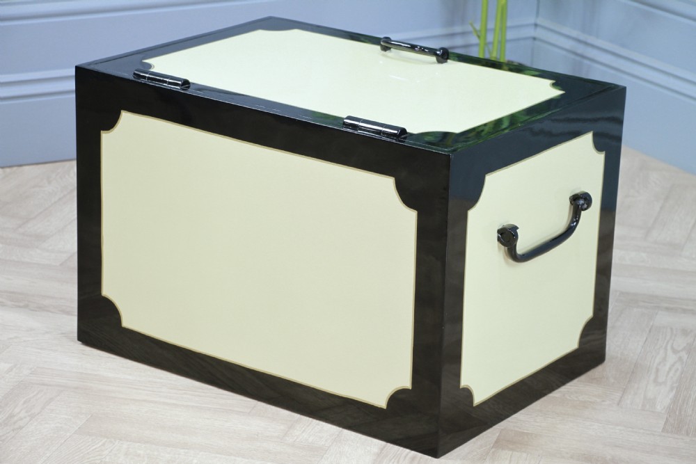 A restored Victorian George Price iron strong box with black painted edges, cream center panels, heavy iron handles, and a brass makers plaque. View XI