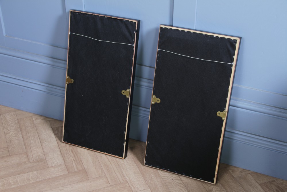 A pair of rectangular carved walnut wall panels featuring detailed grotesque masks and classical urns set within black ebonised frames. View IX