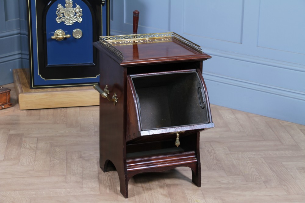 An Edwardian dark mahogany coal purdonium featuring classical floral marquetry inlay, side carry handles, a pierced brass top gallery, and a rear wooden shovel handle. View II