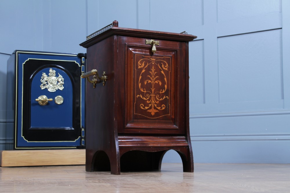 An Edwardian dark mahogany coal purdonium featuring classical floral marquetry inlay, side carry handles, a pierced brass top gallery, and a rear wooden shovel handle. View VII