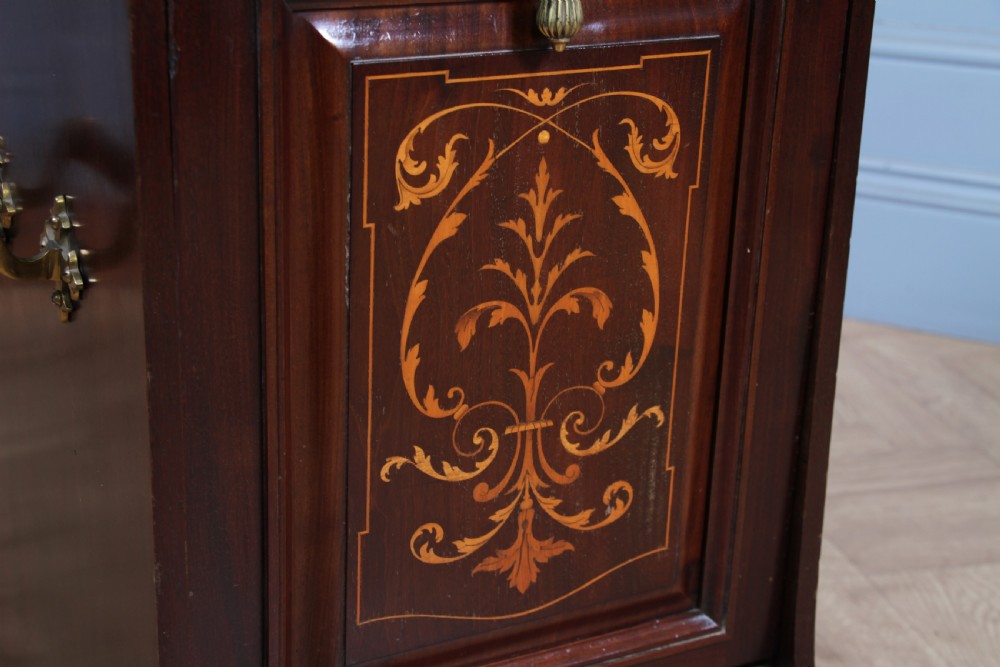 An Edwardian dark mahogany coal purdonium featuring classical floral marquetry inlay, side carry handles, a pierced brass top gallery, and a rear wooden shovel handle. View VIII