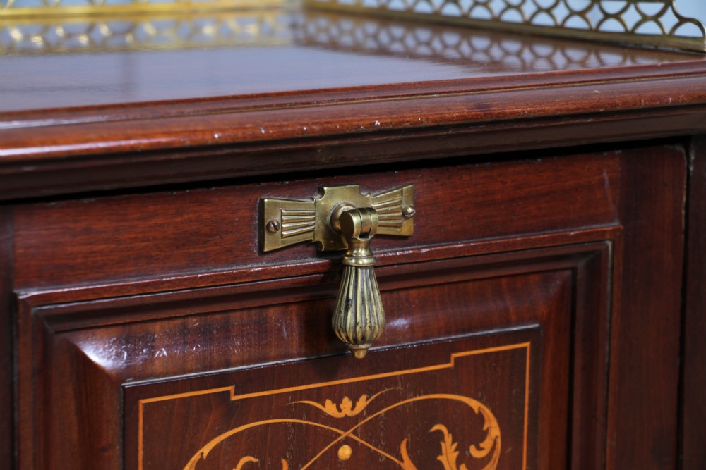 An Edwardian dark mahogany coal purdonium featuring classical floral marquetry inlay, side carry handles, a pierced brass top gallery, and a rear wooden shovel handle. View XI