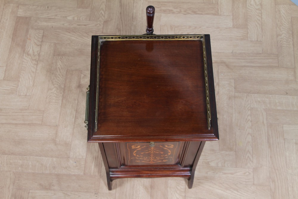 An Edwardian dark mahogany coal purdonium featuring classical floral marquetry inlay, side carry handles, a pierced brass top gallery, and a rear wooden shovel handle. View XIII