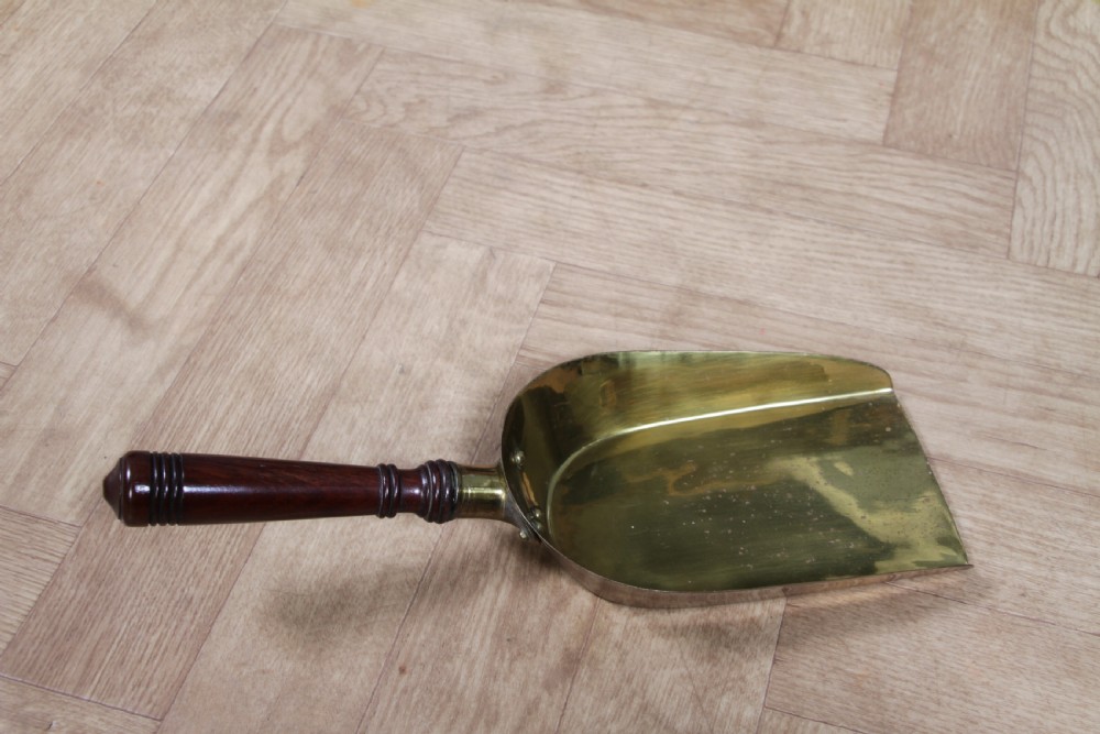 An Edwardian dark mahogany coal purdonium featuring classical floral marquetry inlay, side carry handles, a pierced brass top gallery, and a rear wooden shovel handle. View XVII
