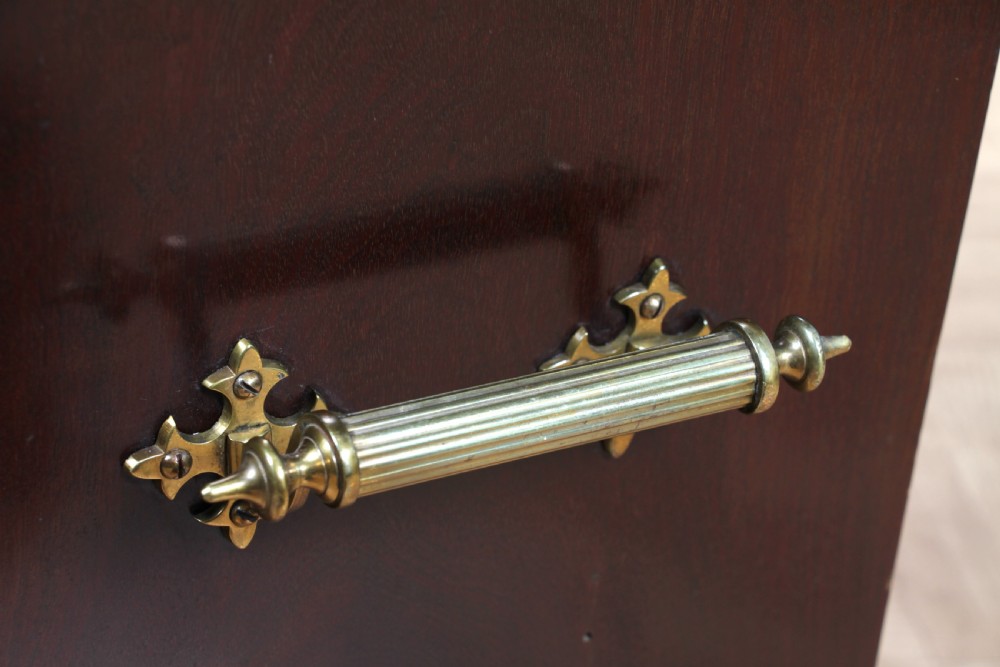 An Edwardian dark mahogany coal purdonium featuring classical floral marquetry inlay, side carry handles, a pierced brass top gallery, and a rear wooden shovel handle. View XIX