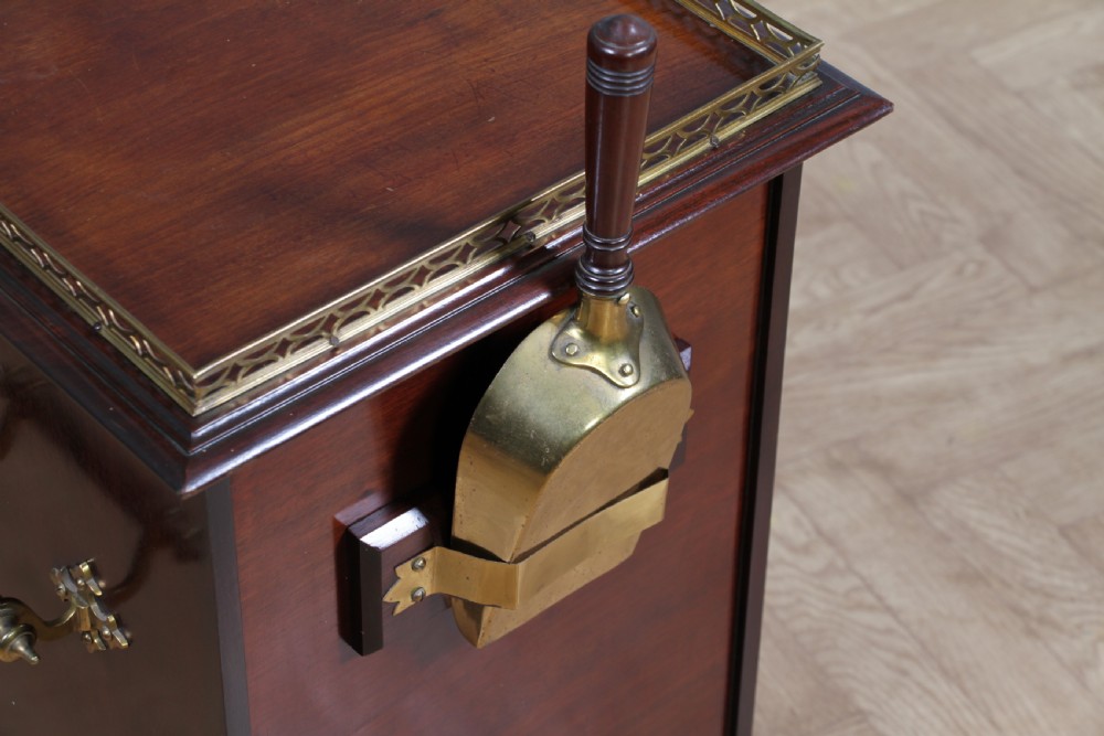 An Edwardian dark mahogany coal purdonium featuring classical floral marquetry inlay, side carry handles, a pierced brass top gallery, and a rear wooden shovel handle. View XXII