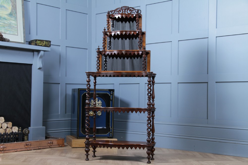 A Victorian six-tier walnut whatnot display shelf featuring hollow barley twist columns, mirrored back panels, and carved fretwork cresting. View VIII