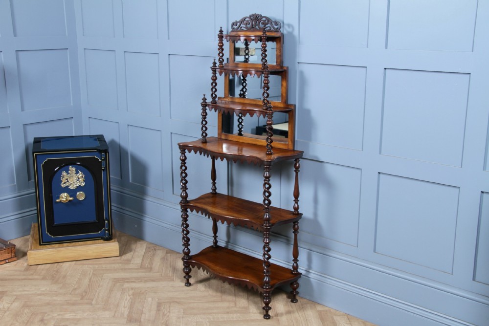 A Victorian six-tier walnut whatnot display shelf featuring hollow barley twist columns, mirrored back panels, and carved fretwork cresting. View XIV