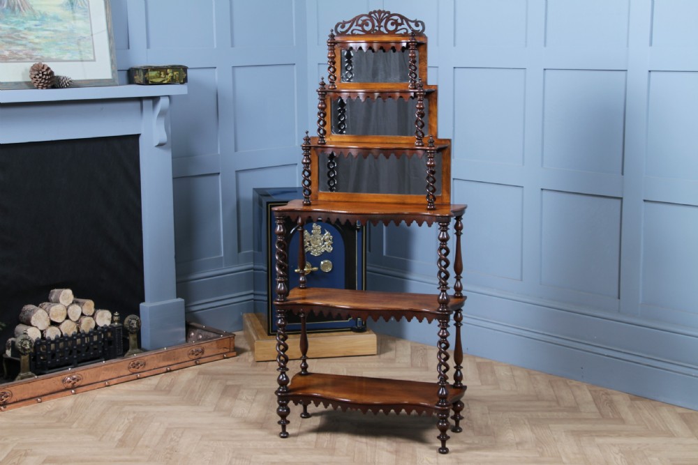 A Victorian six-tier walnut whatnot display shelf featuring hollow barley twist columns, mirrored back panels, and carved fretwork cresting. View XVII