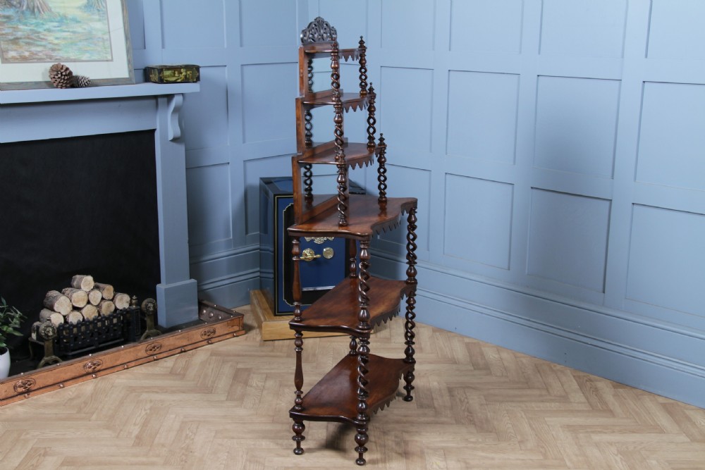 A Victorian six-tier walnut whatnot display shelf featuring hollow barley twist columns, mirrored back panels, and carved fretwork cresting. View XVIII