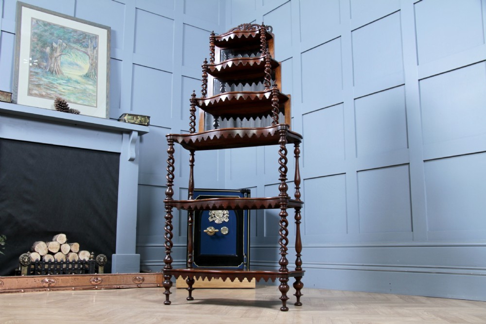 A Victorian six-tier walnut whatnot display shelf featuring hollow barley twist columns, mirrored back panels, and carved fretwork cresting. View XXIII