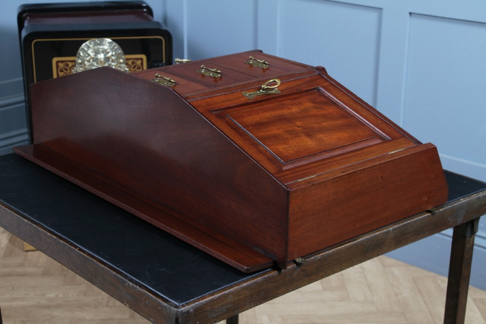 A small Edwardian mahogany wall hanging cabinet featuring two outer cupboards, three central drawers, brass handles, and a low back gallery. View XXIII