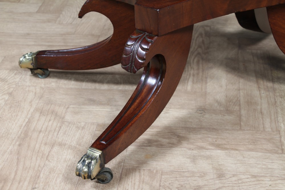 A Regency period mahogany centre table featuring a rectangular top with rounded corners on a central octagonal column and quadform platform base with swept legs. View XIV