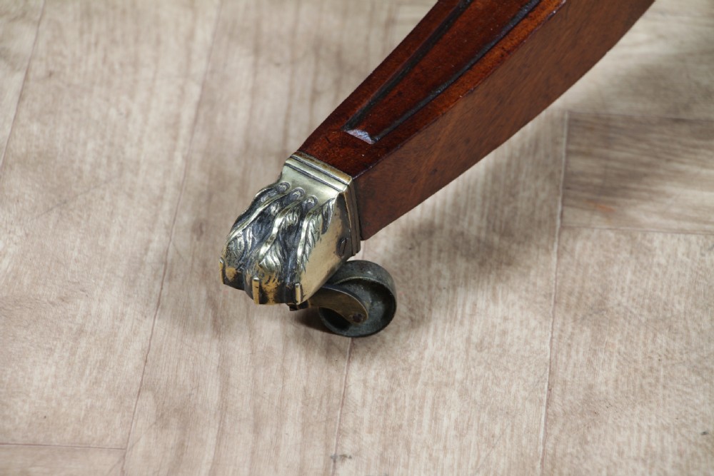 A Regency period mahogany centre table featuring a rectangular top with rounded corners on a central octagonal column and quadform platform base with swept legs. View XV