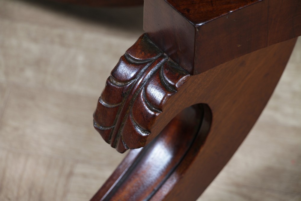 A Regency period mahogany centre table featuring a rectangular top with rounded corners on a central octagonal column and quadform platform base with swept legs. View XVI