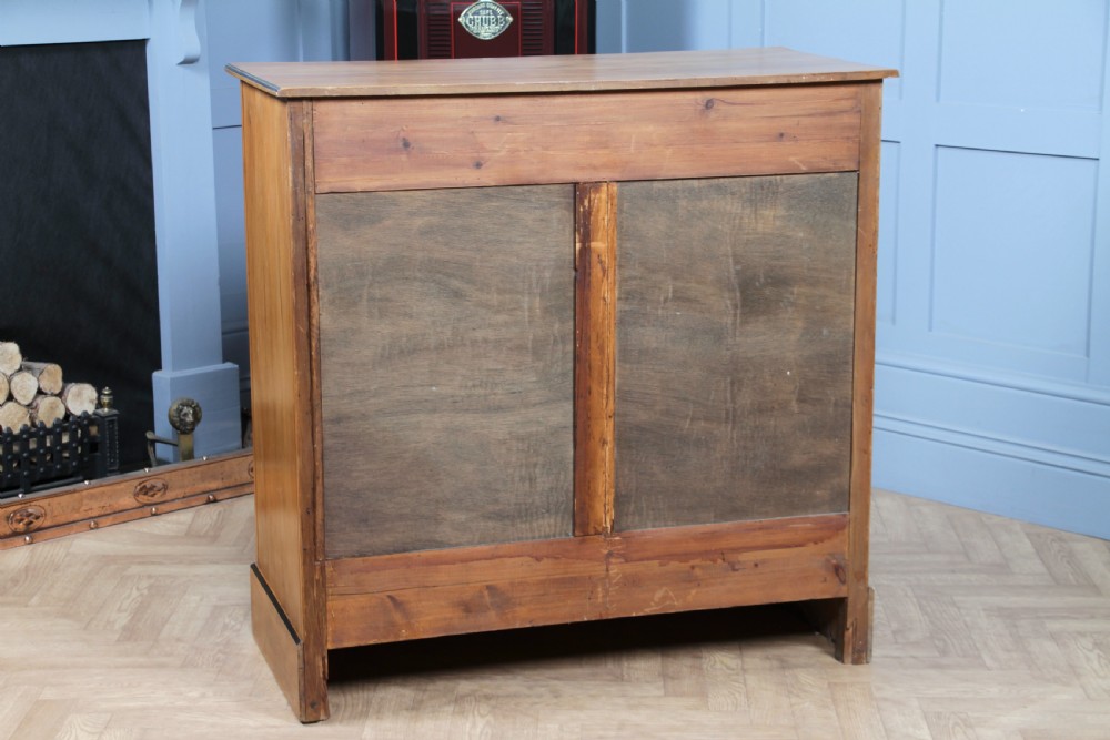 A late Victorian satinwood chest featuring two short drawers above three long drawers with ebonised stringing and dark metal handles on a solid plinth base. View XX