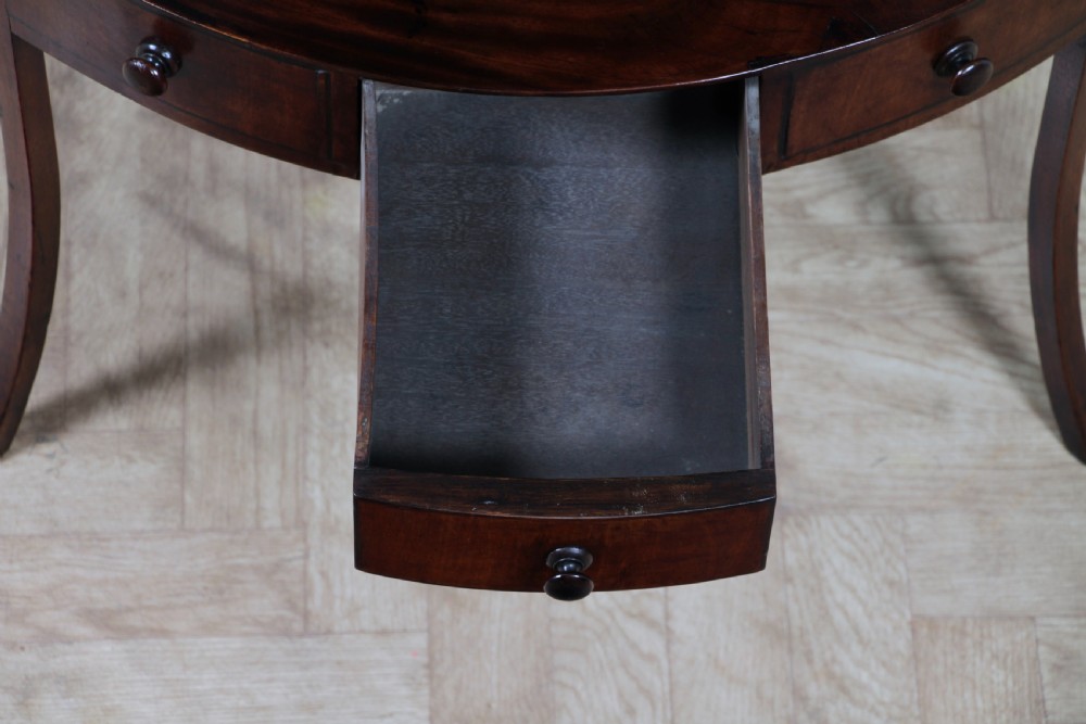 An antique dark mahogany corner washstand featuring a curved splashback with a small top shelf, a middle surface tier, a lower shelf with a central drawer, and splayed legs. View XIII