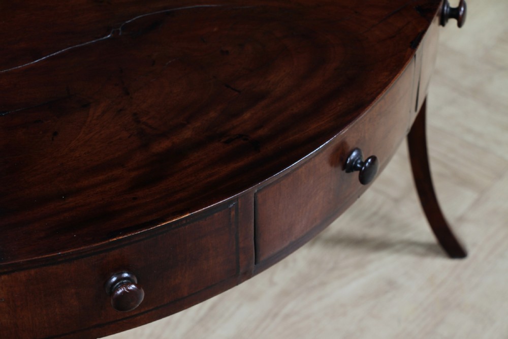 An antique dark mahogany corner washstand featuring a curved splashback with a small top shelf, a middle surface tier, a lower shelf with a central drawer, and splayed legs. View XV