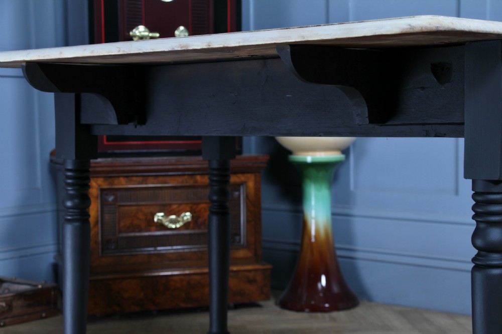 A restored Victorian Pembroke table featuring a bleached mahogany drop-leaf top and a black painted frame with turned legs on brass castors. View XVII