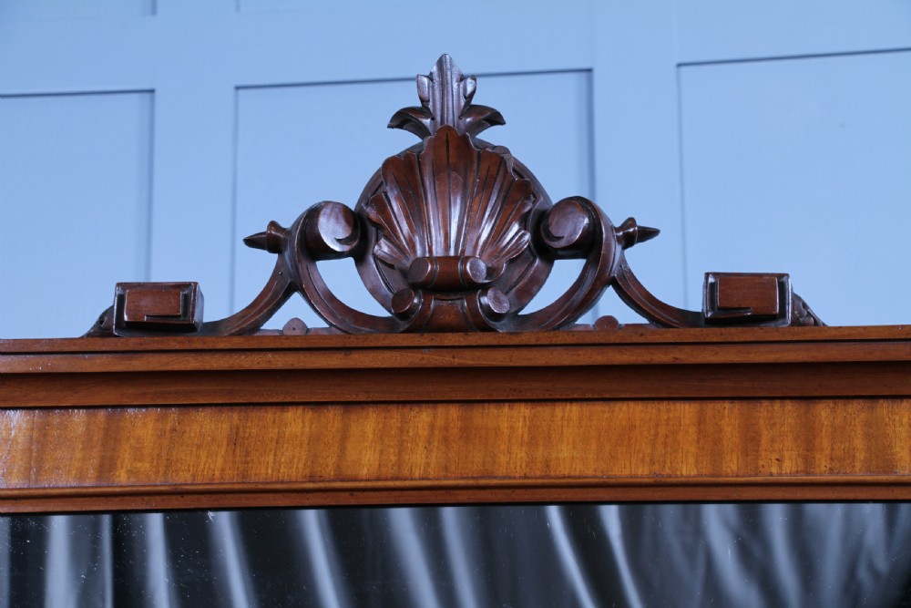 A Victorian mahogany mirror-back sideboard featuring two panelled cabinet doors, upper drawers, tiered side shelves, and a decorative carved cresting. View XVII