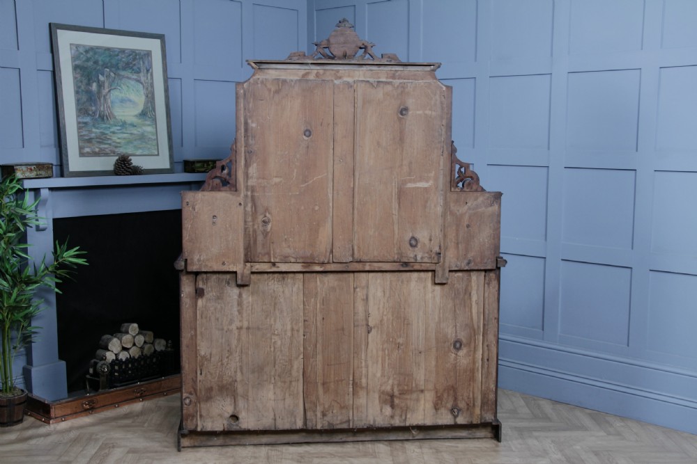 A Victorian mahogany mirror-back sideboard featuring two panelled cabinet doors, upper drawers, tiered side shelves, and a decorative carved cresting. View XXV