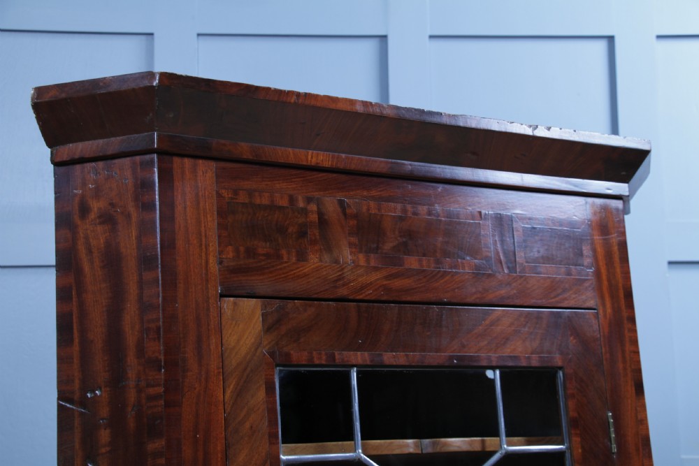 A Georgian mahogany wall-hanging corner cabinet featuring a single door with geometric glazed panels and a small base drawer. View IX