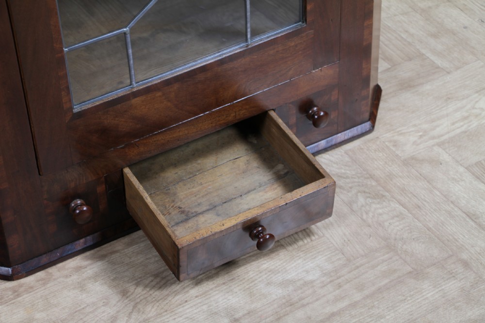 A Georgian mahogany wall-hanging corner cabinet featuring a single door with geometric glazed panels and a small base drawer. View XI