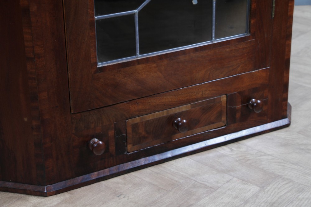 A Georgian mahogany wall-hanging corner cabinet featuring a single door with geometric glazed panels and a small base drawer. View XIII
