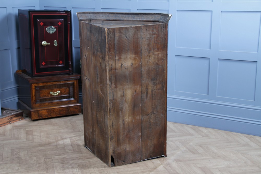 A Georgian mahogany wall-hanging corner cabinet featuring a single door with geometric glazed panels and a small base drawer. View XVI
