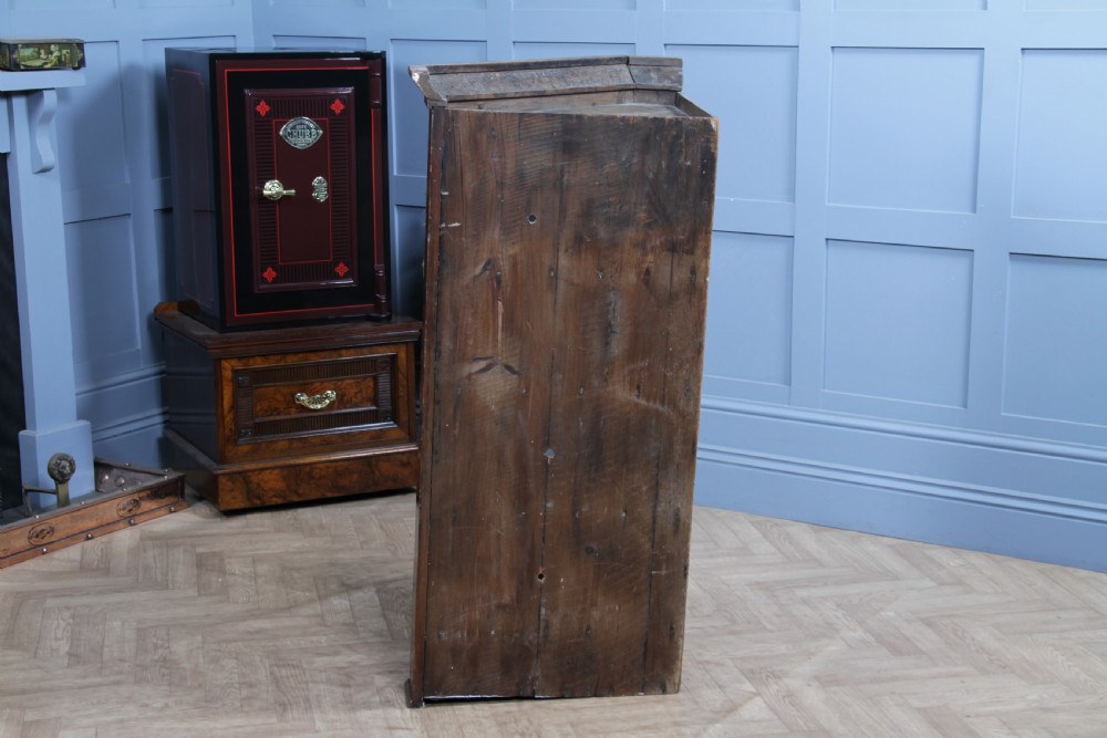 A Georgian mahogany wall-hanging corner cabinet featuring a single door with geometric glazed panels and a small base drawer. View XVII