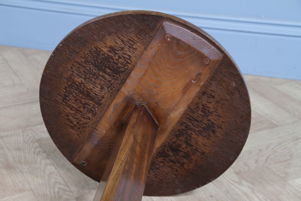 An antique William IV mahogany wine table featuring a circular top supported by a tapered faceted column and a triform base with bun feet. View XV