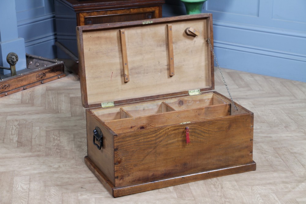 A rectangular solid elm tool chest featuring hand-cut dovetail joints, black iron side handles, and a warm wood grain finish. View IV