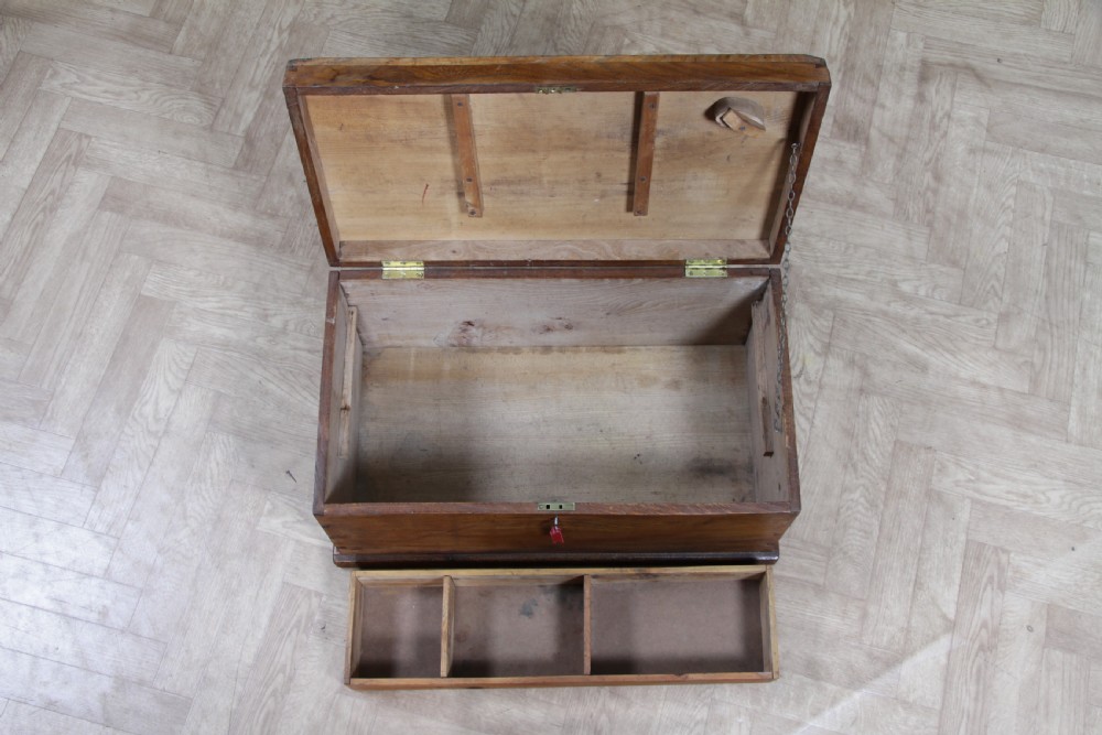 A rectangular solid elm tool chest featuring hand-cut dovetail joints, black iron side handles, and a warm wood grain finish. View V