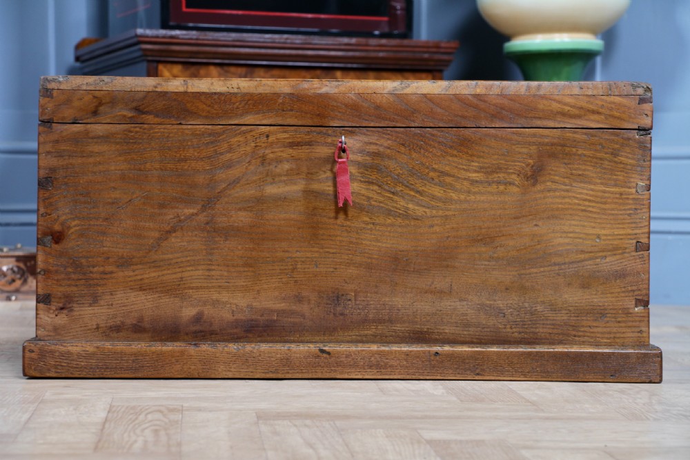 A rectangular solid elm tool chest featuring hand-cut dovetail joints, black iron side handles, and a warm wood grain finish. View IX