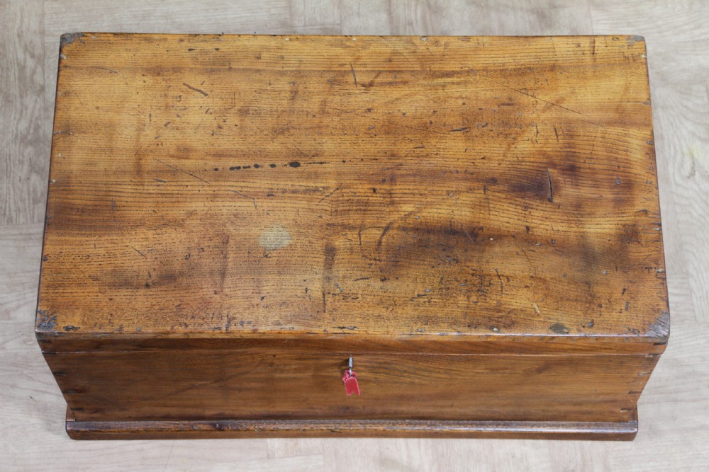 A rectangular solid elm tool chest featuring hand-cut dovetail joints, black iron side handles, and a warm wood grain finish. View XIII