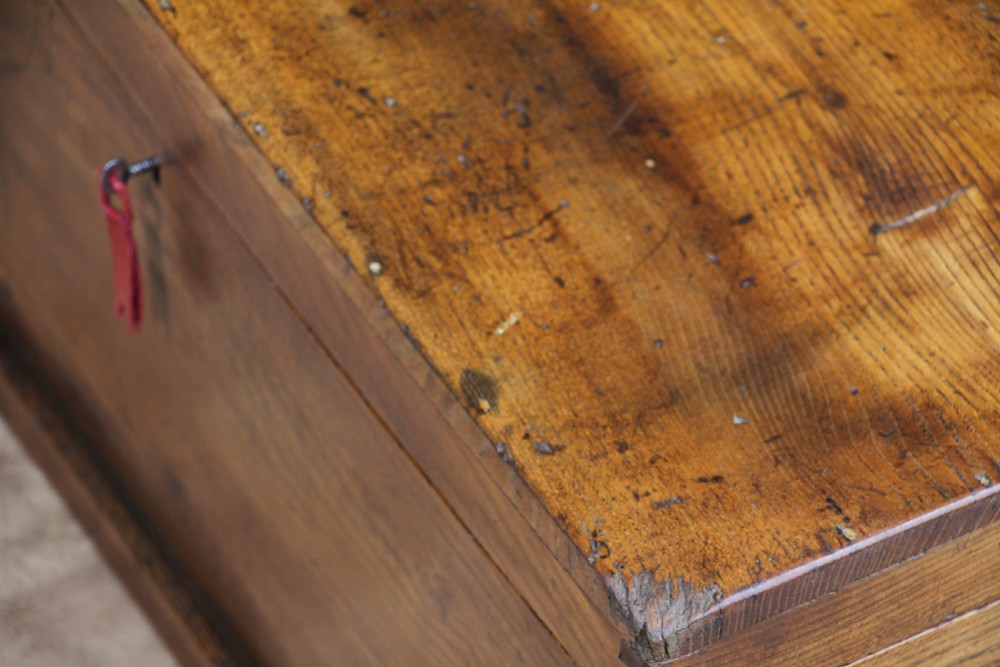 A rectangular solid elm tool chest featuring hand-cut dovetail joints, black iron side handles, and a warm wood grain finish. View XVI