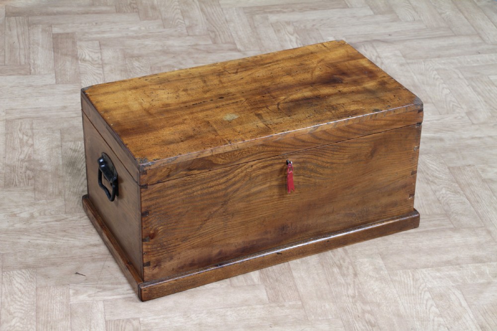 A rectangular solid elm tool chest featuring hand-cut dovetail joints, black iron side handles, and a warm wood grain finish. View XIX