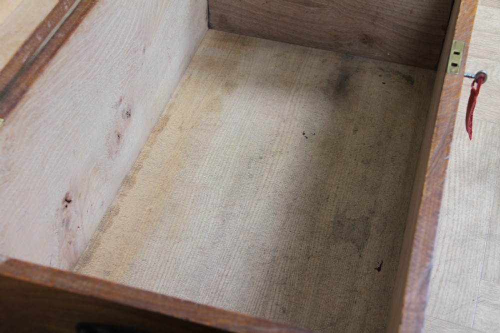 A rectangular solid elm tool chest featuring hand-cut dovetail joints, black iron side handles, and a warm wood grain finish. View XXI