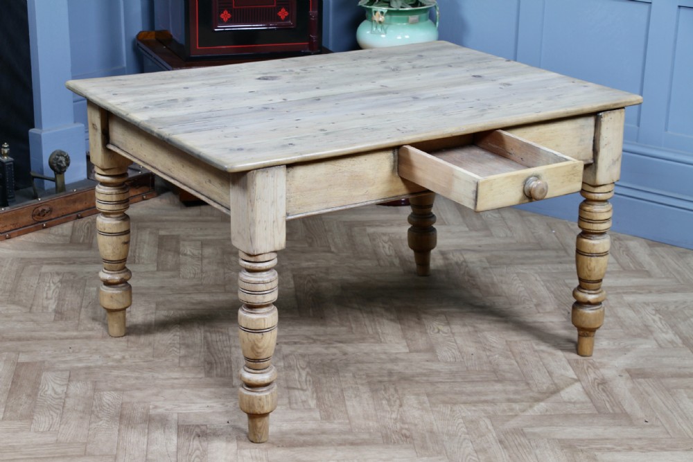 A restored Victorian pine kitchen table featuring a scrubbed rectangular plank top, a single frieze drawer with a wooden knob, and four turned legs. View III