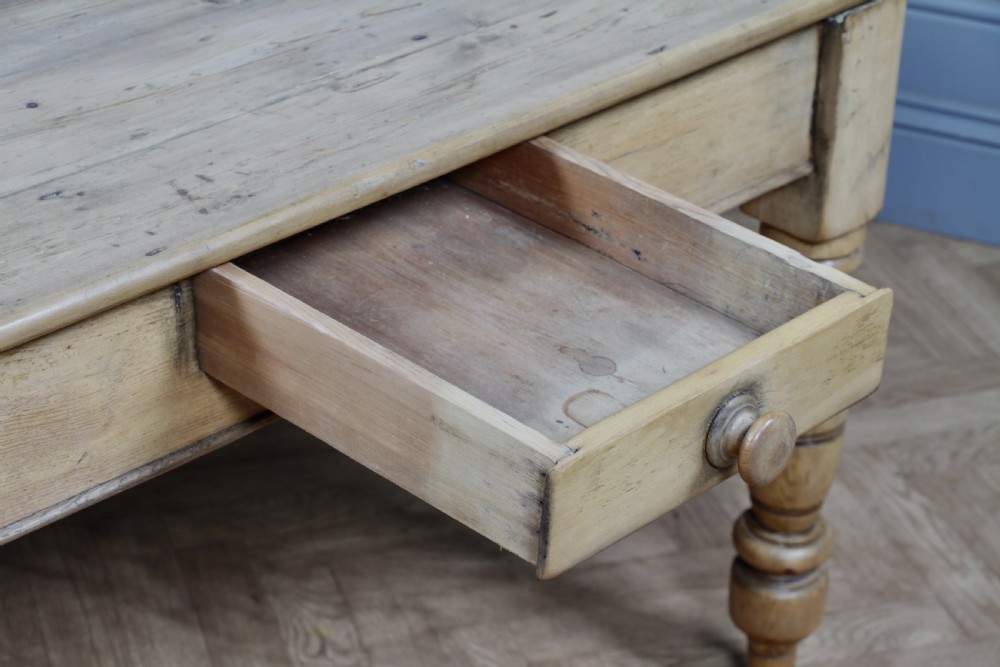 A restored Victorian pine kitchen table featuring a scrubbed rectangular plank top, a single frieze drawer with a wooden knob, and four turned legs. View IV
